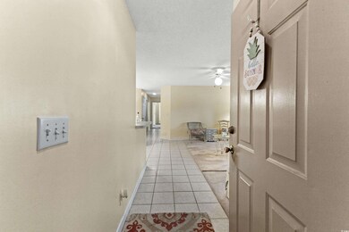 Corridor featuring light tile patterned flooring a