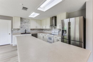 Kitchen with stainless steel appliances, wall chi