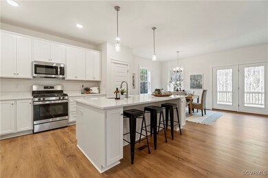 Kitchen with a sink, light wood-style floors, ligh