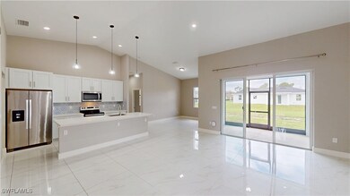 Kitchen with stainless steel appliances, a sink, t