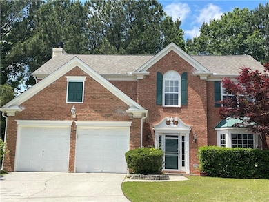 View of front of house featuring concrete driveway
