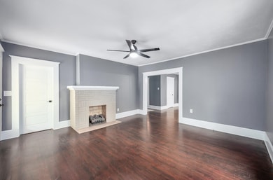 Unfurnished living room featuring ornamental moldi
