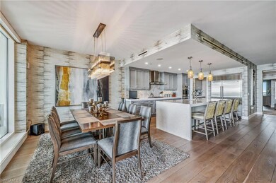 Dining space with wood-type flooring and a chandelier