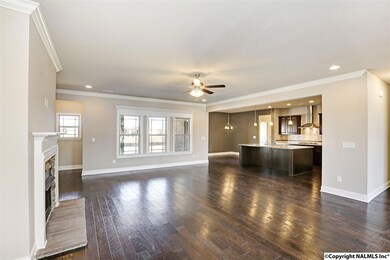 Rich scraped hardwoods, crown molding, natural gas fireplace, and beautiful tripleset windows make this open air space oh so cozy.