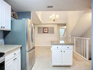 Kitchen view to dining room with soaring ceiling