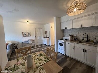 Kitchen featuring white cabinetry, white gas range