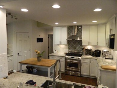 No expense spared in this custom kitchen!  Beautiful tile work behind the new gas range.  SS hood!  Everything is new!