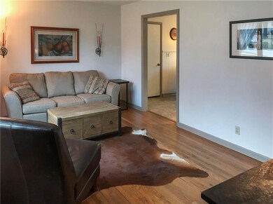 living room with hardwood floors and leads into th