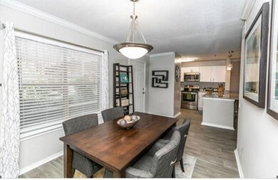 Dining space featuring ornamental molding and wood