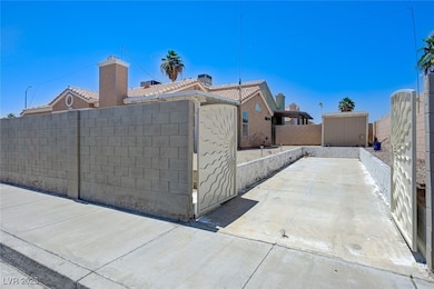 View of side of home featuring a tiled roof, a chi