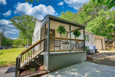 Rear view of house featuring covered porch and a l