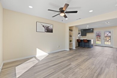 Unfurnished living room featuring ceiling fan, fre