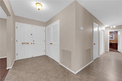 Entrance foyer with tile patterned flooring, baseb