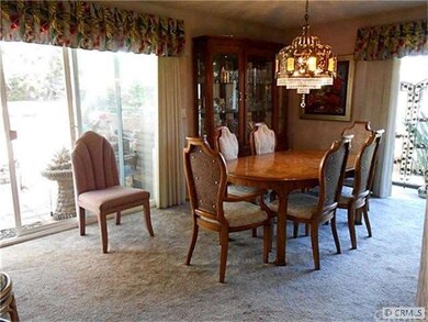 Large dining area has view of patio and greenbelt.