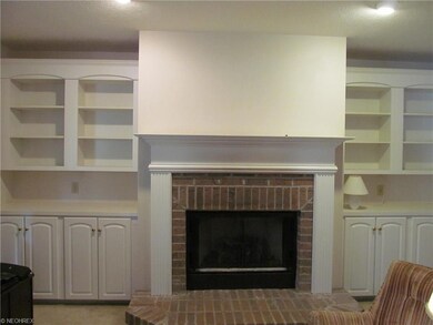 Living room with gas fireplace and built ins.