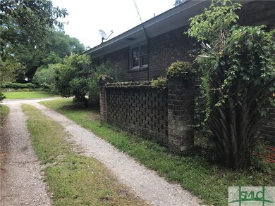 Side of house with alley leading to carport area f