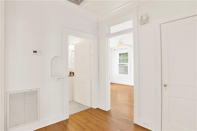 Hallway with attic access, visible vents, ornament