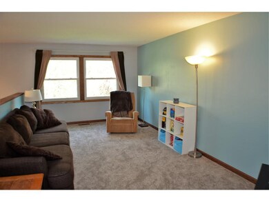 The upper level living room is bright and airy to 