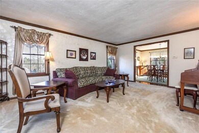 The Living Room features plush neutral carpeting, 