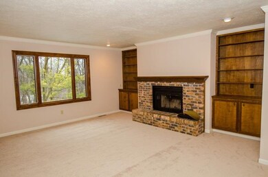 Roomy living space with wood burning fireplace.