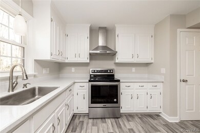 Kitchen with wall chimney range hood, pendant ligh