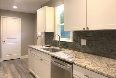 Leathered granite countertops and stacked stone ba