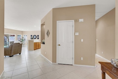 Hallway featuring light tile patterned floors and
