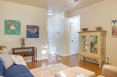 Living area featuring light wood-style flooring and baseboards