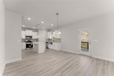 Stock PhotoUnfurnished living room featuring light wood-type flooring, recessed lighting, baseboards, and a sink
