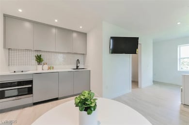 Kitchen featuring stainless steel oven, gray cabin