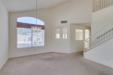 Spare room with carpet flooring, a towering ceilin