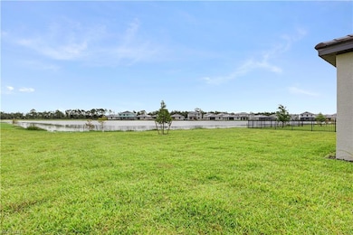 View of yard with a water view and fence