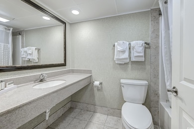 Bathroom featuring crown molding, a sink, and toilet