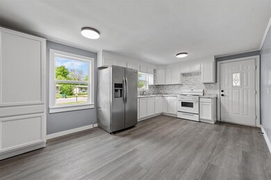 Kitchen with stainless steel fridge with ice dispenser, hardwood / wood-style floors, white range with gas cooktop, and white cabinets