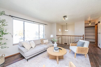 Living area with dark wood-type flooring and a textured ceiling