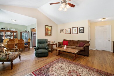 Living room featuring lofted ceiling, light hardwo