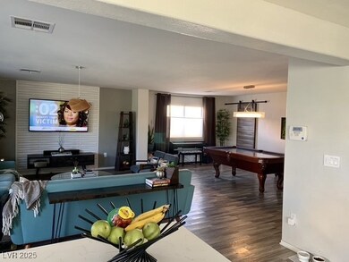Living area featuring dark wood-style floors, pool