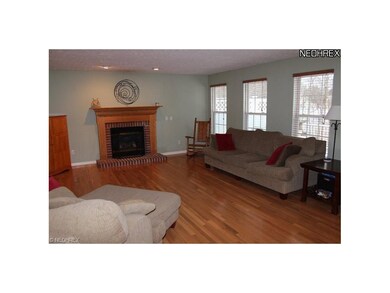 Great room with hardwood floors and gas fireplace.