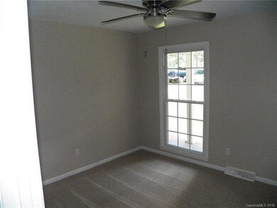 BEDROOM 1 WITH NEW CARPET AND OVERSIZE 6' WINDOW