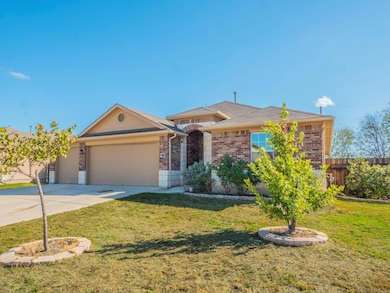 Single story home with brick siding, driveway, and an attached garage