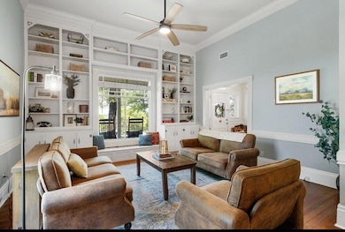 Living area featuring visible vents, ornamental m