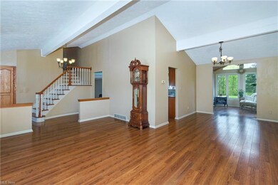 Vaulted Living Room & dining Room with Beamed Ceiling