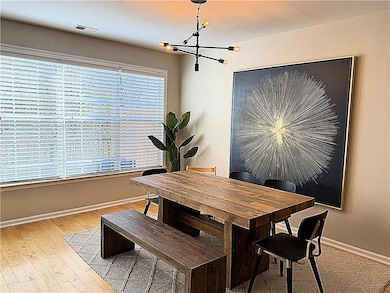 Dining room featuring a chandelier and light hardwood flooring