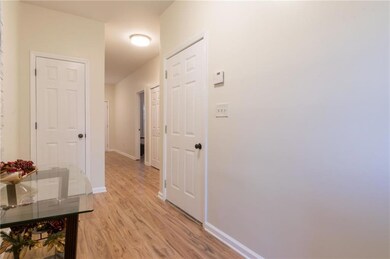 Hallway with light hardwood / wood-style floors