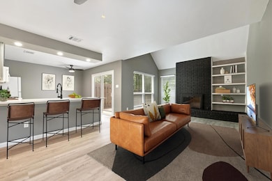 Living room featuring a ceiling fan, plenty of na
