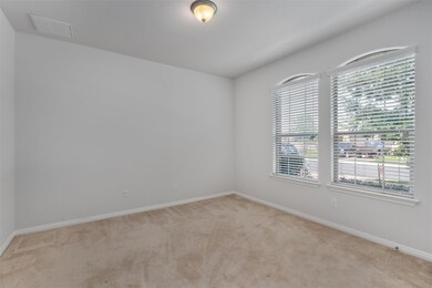 Spare room featuring light colored carpet and ple