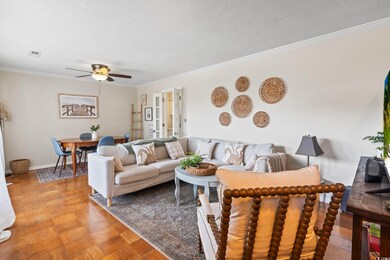 Living room featuring ornamental molding, light pa