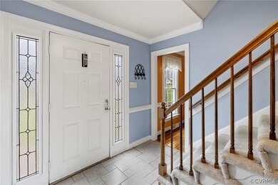 Step into the foyer with ceramic tile floor, stain
