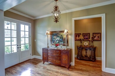 Welcoming entry with double front doors and rich h