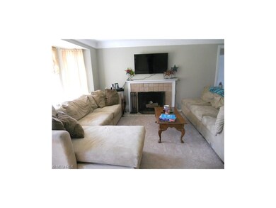Living Room with Bay Window and Woodburning Firepl